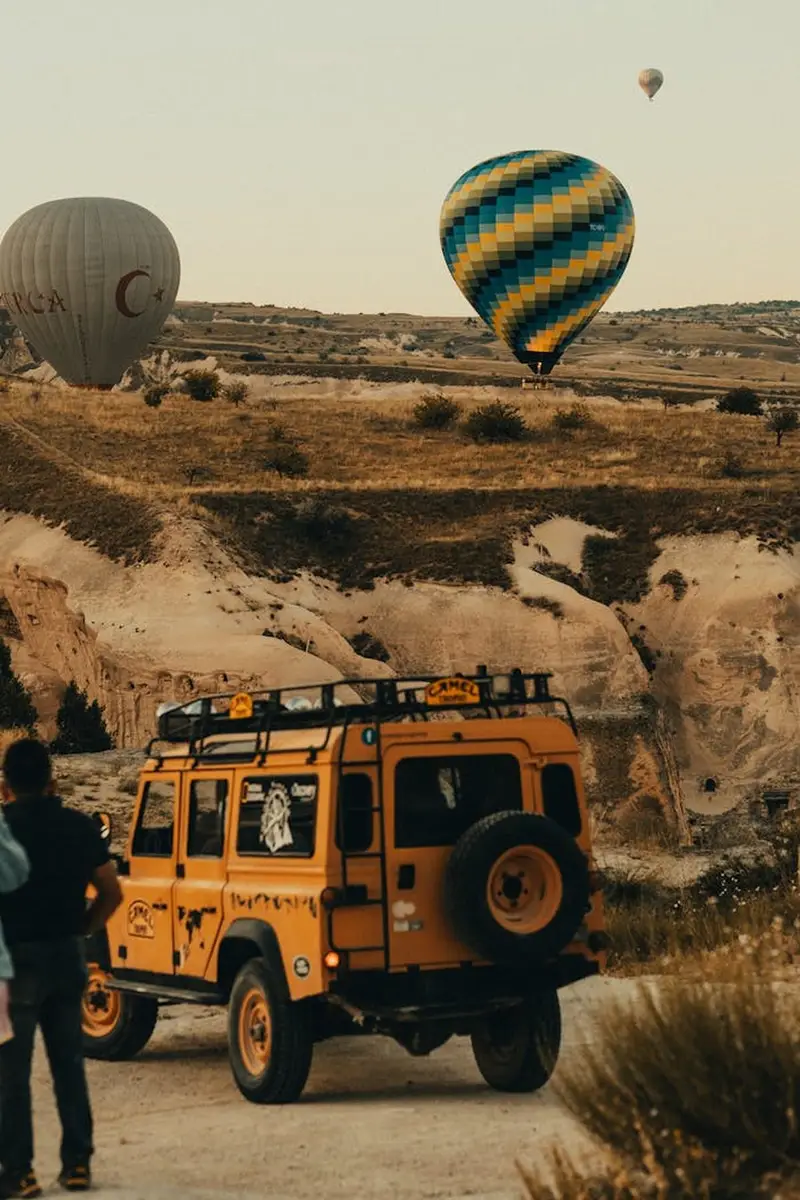 Land Rover Defender 110 driving a misty forest trail